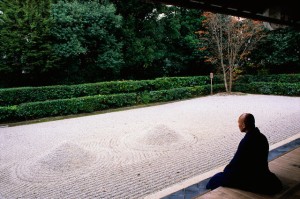 Monk Meditating at a Rock Garden